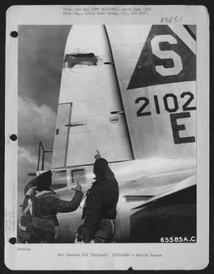 Battle Damage > Lt. G.F. Carter And Lt. L. H. Ludeman Examine The Damaged Tail Section Of Their Boeing B-17 "Flying Fortress" Of The 401St Bomb Group At An 8Th Air Force Base In England.  16 June 1944.