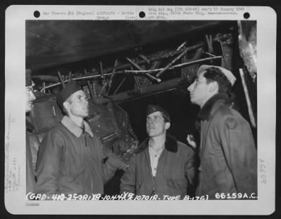 Thumbnail for Battle Damage > Crew Members Look At Their Damaged Boeing B-17 "Flying Fortress" Of The 381St Bomb Group, England, 8 October 1944.  (Aircraft No. 107018).