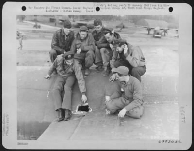 Battle Damage > Crew Members Of The 386Th Bomb Group Inspect Damage Done To Their Plane By Flak During A Mission On 18 April 1944.  Great Dunmow, Essex, England.