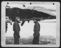 Men Of The 379Th Bomb Group Examine The Wing Of A Boeing B-17 (A/C No. 633) Which Was Damaged During A Mission Over Enemy Territory On 29 January 1945.  England. - Page 1