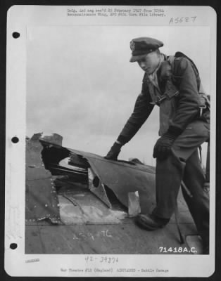 Thumbnail for Battle Damage > Lt. Flottrop, Of The 390Th Bomb Group, Examines The Damage Done To His Boeing B-17 "Flying Fortress" While On A Mission Over Enemy Territory.  8Th Air Force Base, England, 11 March 1944.