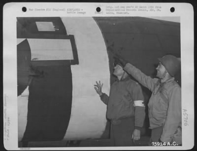 Thumbnail for Battle Damage > Two Members Of The 439Th Troop Carrier Group Examine Flak Damage On A Douglas C-47 At An Air Base Somewhere In England.  7 June 1944.