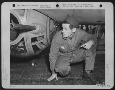 Thumbnail for Battle Damage > Sgt. Roger Mcdermott, Detroit, Mich, Ball Turret Gunner In The Boeing B-17 "The Great Speckled Bird" Holds His Breath And Crosses His Fingers As He Looks At The Hole Where A .20 Mm Cannon Shell Entered His Ball Turret, Circled Around Inside And Left Him U