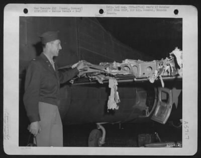 Thumbnail for Battle Damage > Lt. Colonel Burton R. Baldwin, Tracy, Calif., Looks Over The Shattered Tail Of His B-17, Photo Reconnaissance Plane, Which Was Damaged During The Historical Airborne Invasion Of Wesel, Germany.  16 April 1945.