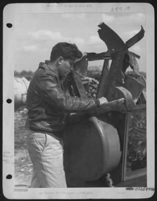 Thumbnail for Battle Damage > S/Sgt. Eugene Gaskins Of Jacksonville, Fla., Peers Into Twisted Hulk Of The Nose Turret Of The Consolidated B-24 Liberator "Vadie Raye".  The 20 Year Old Gunner Bailed Out Of The Blazing Aircraft From An Altitude Of 800 Feet After It Had Been Set Afire By