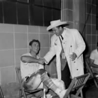 Thumbnail for Billy Cannon, left in the dressing room as he receives thanks from the Houston Oilers owner, Bud Adams, in Houston, Texas, Jan. 1, 1960..JPG