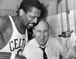 Bill Russell holds Auerbach under a shower.jpg