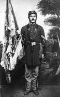 Wm Irvine holding tattered regimental flag from Gettysburg.jpg