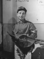 Thumbnail for johnny-longden-smiling-and-holding-saddle.jpg