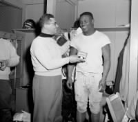 Vince Lombardi, left, admiring watch presented to Mel Triplett.jpg