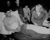 800px-Marlene_Dietrich signs a soldiers cast in Belgium WWII.jpg