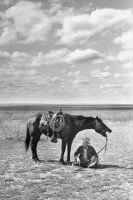 Thumbnail for Clarence Hailey Long sits in shade of his horse.jpg