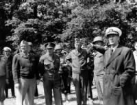 Gen “Hap” Arnold, Gen Dwight Eisenhower, MajGen “Cowboy Pete” Corlett (helmet), Gen George Marshall, LtGen Omar Bradley (pointing).jpg