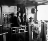 Daisy Suckley, left, on a train with President Roosevelt in 1943.jpg