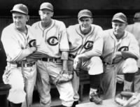 Thumbnail for Larry French, from left, Lon Warneke, Bill Lee and Charlie Root look on from the dugout before a September 1935 game at Wrigley Field in Chicago.jpg