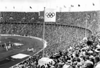 Thumbnail for The Olympic Flag flying next to the Personal standard of Adolf Hitler over the Olympic Stadium, Berlin 1936.jpg