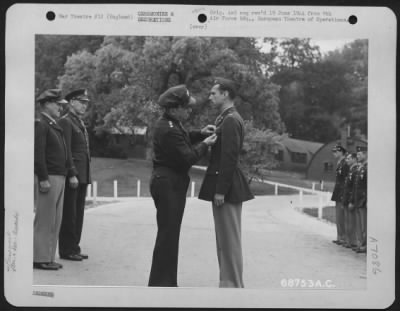 Awards > Colonel James Ferguson Is Presented The Distinguished Flying Cross By Lt. General Lewis H. Brereton.  Brig. General Vic H. Strahm And Brig. Gen. Otto P. Weyland Stand In The Background.  31 May 1944, England.