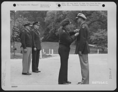 Awards > Colonel Lance Call Is Presented The Distinguished Flying Cross By Lt. General Lewis H. Brereton.  Brig. General Vic H. Strahm And Brig. Gen. Otto P. Weyland Stand In The Background.  31 May 1944, England.