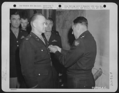 Awards > Colonel Mustoe, Attached To Hdq., 1St Bomb Division, Is Presented An Award By Major General Robert B. Williams During A Ceremony On 25 June 1944 At An 8Th Air Force Base In England.