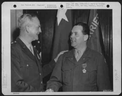 Awards > Colonel Mcbride Is Congratulated By Major General Paul L. Williams Of The 9Th Troop Carrier Command, During A Ceremony Somewhere In England.  2 June 1945.