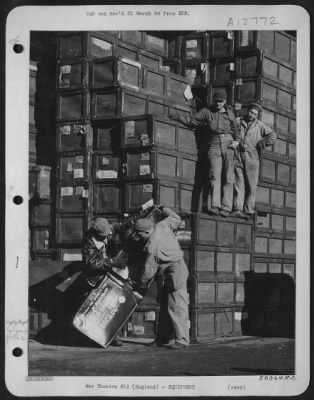 Thumbnail for General > Supply men at depot shown uncrating self-sealing fuel tanks. Countless crates are stacked away for immediate use.