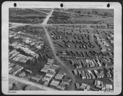 Thumbnail for General > INVASION PREPARATION somewhere in England during training for the ofrth-coming invasion. In the foreground are crated gliders, in the center of the photo are uncrated fuselages, and above, nearer the top of the photo, are completely assembled glider