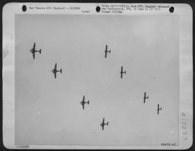 General > A pattern of transport planes and gliders is pictured against a grey English sky as the 9th Air force Troop Carrier Command sends load after load of airborne infantry reinforcements into the area where the Yank paratroopers were dropped in France