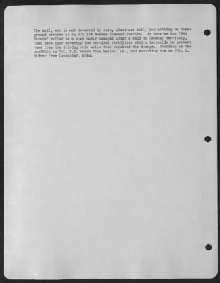 Thumbnail for General > The mail, who is not deterred by rain, sleet nor hail, has nothing on these ground crewmen at an 8th AAF Bomber Command station. As soon as the "Hit Parade" rolled to a stop badly damaged after a raid on Germany territory, they were busy covering