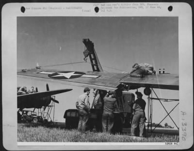 Thumbnail for General > Their wings don't stay clipped long. Here with the aid of a truck-borne crane, workers remove "Charlie's" outboard wing section to begin work on the sheared cables inside; it's all in a day's work!