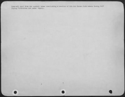 General > Overall shot from the control tower overlooking a section of 8th Air force field where Boeing B-17 Flying ofrtresses are under repair.