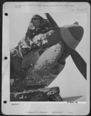 Thumbnail for General > Ground crewmen carry on the prelininary fight with the elements, and in a few minutes this fighter will be ready to climb aloft to eerie heights, escorting U.S. Eighth Air force heavy bombers hitting von Rundstedt's supply lines. Sgt. Richard Cleary