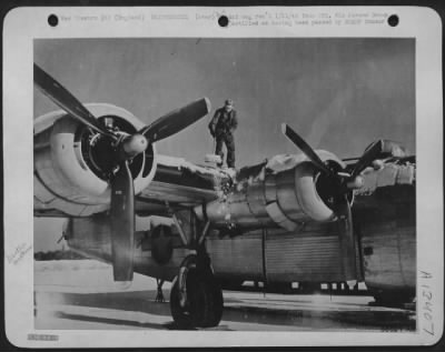 Thumbnail for General > When snow blanketed the Eighth Air force bases in England recently, ground crewmen had snow to remove from their Consolidated B-24 Liberators before they could begin work on them. In spite of the snow, ground crewmen maintained their planes and kept