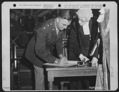 Thumbnail for Miscellaneous > Major General Howard M. Turner Signs The Book Which Made Him A Freeman Of The Borough Of Bedford, England During A Ceremony On 19 July 1945.