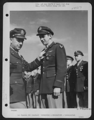 Thumbnail for Unidentified > An Officer Presents The Air Medal To A Member Of The 314Th Service Group Of The 364Th Fighter Group During A Ceremony At An Airbase Somewhere In England.  25 May 1944.