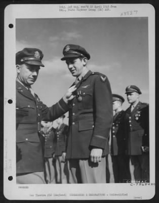 Thumbnail for Unidentified > An Officer Presents The Air Medal To A Member Of The 314Th Service Group Of The 364Th Fighter Group During A Ceremony At An Airbase Somewhere In England.  25 May 1944.