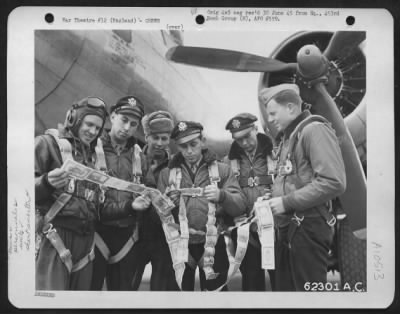 General > Lt. Whitson And Crew Of The 493Rd Bomb Group, 8Th Air Force Look At Some Of The Short Snorters Collected By Crew Members.  6 April 1945, England.