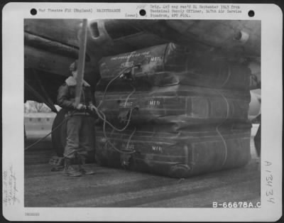 Thumbnail for General > Large Rubber Lift Bags Are Used To Aid In Jacking Up A Boeing B-17 "Flying Fortress" Whose Landing Gear Has Collapsed.  The Lift Bags Are Rolled Beneath The Wing And Inflated Until The Necessary Pressure Is Exerted To Raise The Wing.  Rubber Was Chose As