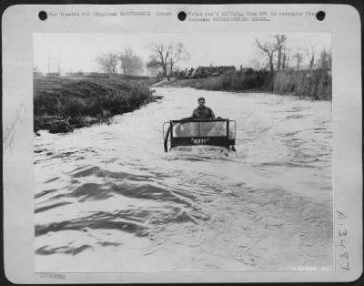 Miscellaneous > Somewhere in England, the U.S. Army 9th Air force maintains a waterproofing school were soldier mechanics are taught to treat vehicles in order that they may travel through fairly deep water without stalling. Asbestos compound is applied to the motor