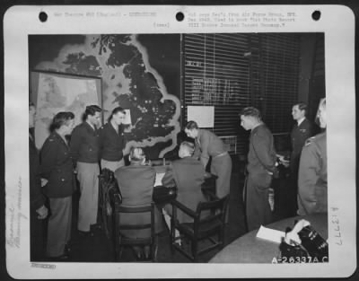 General > Planning a bombing mission in operations room: left to right: Maj. George Jones, Col. Harris Hull, Lt. Col. Stuart Porter, Lt. Col. W.H. Cleveland, Co. C.B.B. Bubb, Brig. Gen. N. Longfellow, Capt. C.F. Bourne, Maj. R.H. Stuart, Wing Commander Duke