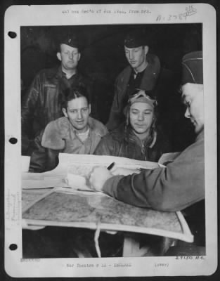 Thumbnail for General > HIS TOUR OF MISSIONS COMPLETED: 1st Lt. Leroy Faringer (wearing goggles) sits for final interrogation on his return from a bombing mission over northwest Germany on 22 Dec. Lt. Faringer, 27, of Texarkana, Texas, is navigator of ofrtress "Demo