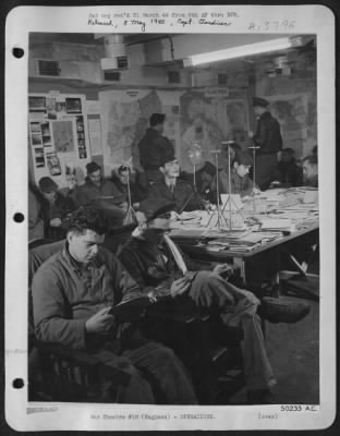 Thumbnail for General > Combat crew men of Liberator spend their spare hours in base intelligence library studing S-2 reports, operational pictures, models of enemy aircraft, and battle maps of all theaters, etc., in order that they may keep constantly abreast of