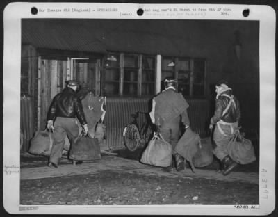 Thumbnail for General > Flying crew members entering operations hut uponn return from mission. They're carrying parachute bags, wearing flak belts and other flying gear. Interrogation ofllows.