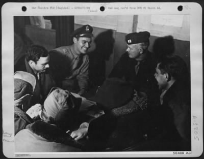 Thumbnail for General > Flying ofrt "Dream Baby" crew are interrogated uponn their return from an 8th AAF attack on Augsburg, on 16 March, Pilot 2nd Lt. Ewing S. Watson, Bowie, Tex. (left) is shown talking to Interrogation officer (center).