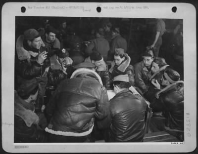 Thumbnail for General > Crew of "Idiot's Delight," Boeing B-17 veteran with 42 missions to her credit, is seen being interrogated by Intelligence Officer shortly after returning from the 8 March 44 raid on Berlin. In the background the crew of "Tremblin Gremlin" goes