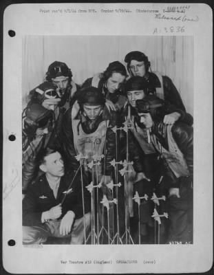 General > Capt. Jack R. Westwood, 30, of Lewiston, Idaho, instructs the combat fliers on the finer points of formation flying in order to effectively bring their .50 caliber machine guns into an interlacing pattern. Westwood, ofrmerly a flier with the RAF