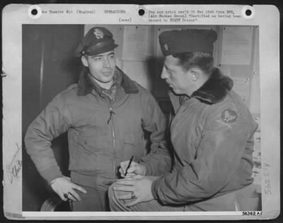 Thumbnail for General > 1st Lt. Manofrd O. Croy Jr., of Seattle, Washington, tells Major Harry L. Downing of Lincoln, Nebraska, operations officer of U.S. 8th AF 82nd Fighter Squadron, how he and his flight of North American P-51 Mustangs destroyed 10 locomotives and other