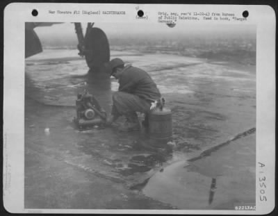 Thumbnail for Miscellaneous > A B-17 "Flying Fortress" Mechanic Of The Eighth Bomber Command Warms His Hands Between Jobs At An Air Base Somewhere In England.