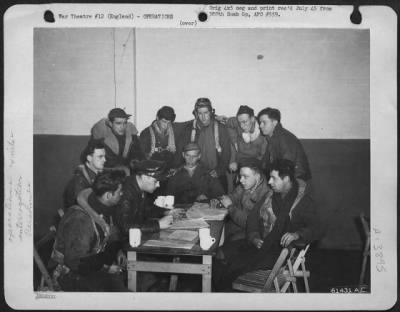 Thumbnail for General > Flight Crew Of The 563Rd Bomb Squadron, 388Th Bomb Group, At Interrogation Table Following Return From A Mission.  England 23 March 1944.  Standing, Left To Right: T/Sgt. Joseph J. Stankevich, Detroit, Mich.; S/Sgt. Sydney Schnieder, Brooklyn, N.Y. S/Sgt.