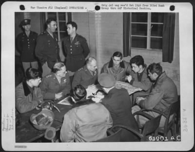 General > General Carl Spaatz And Lt. General Jimmy Doolittle Discuss Results Of Bombing Raid On Oil Refinery At Halle, Germany, With Crews Who Participated In The Mission.  303Rd Bomb Group, England.  31 March 1945.