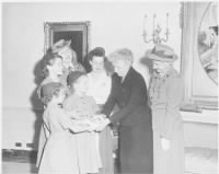 Thumbnail for Photograph_of_First_Lady_Bess_Truman_at_the_White_House_with_a_delegation_of_Girl_Scouts,_who_are_presenting_her_with..._-_NARA_.jpg